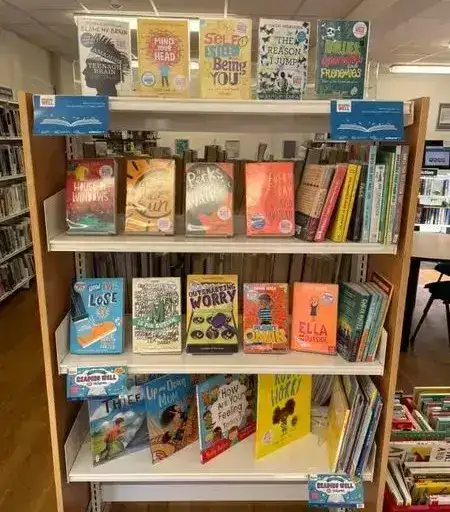Library book shelf with "Reading Well" books