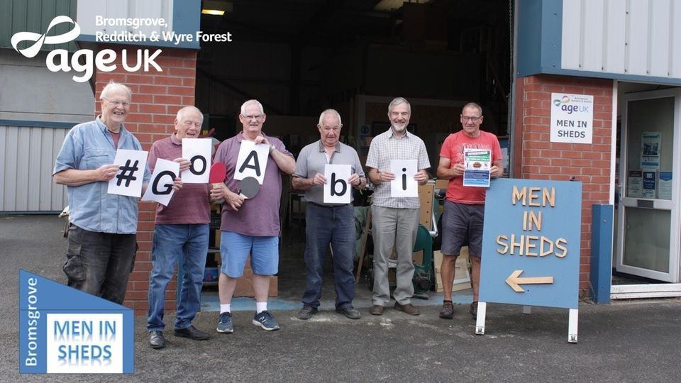 Men in sheds - Age UK incentive - 6 men holding letters that spell Go Abi