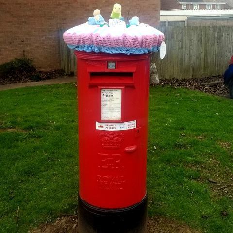Post box with a crochet bonnet depicting an easter scene